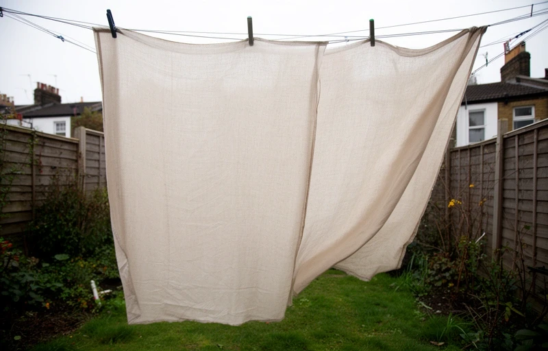 Linen curtain panel drying on a line