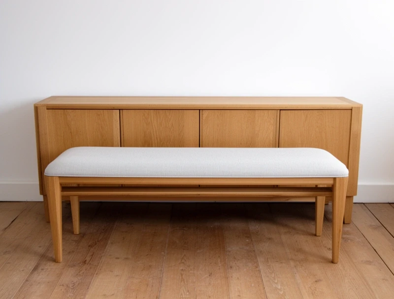 Ash bench and oak sideboard against a white wall